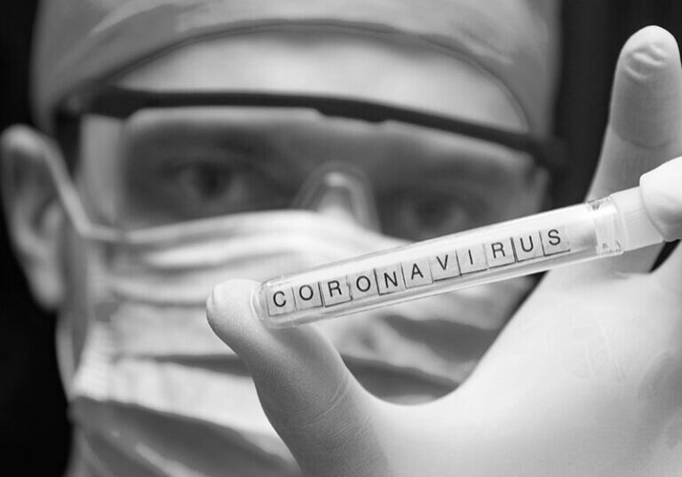 Coronavirus test tube held by doctor with mask and gloves