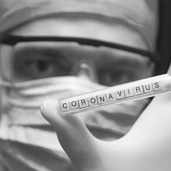 Coronavirus test tube held by doctor with mask and gloves